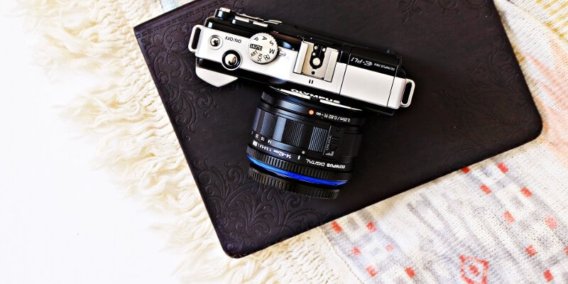 The best tools for bloggers image optimization header image of photo camera on top of black notebook