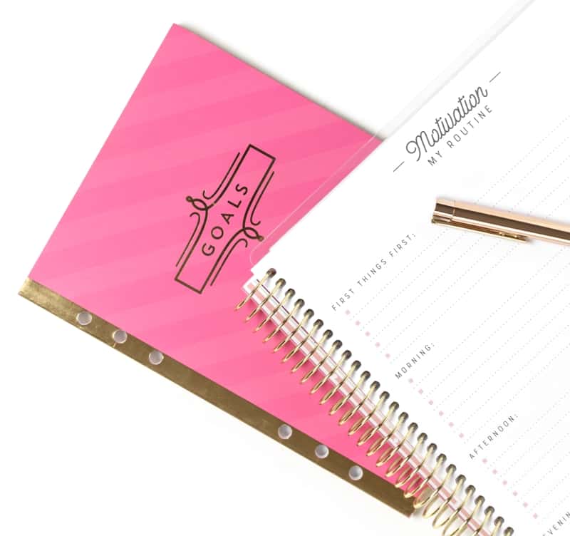 Bright Pink Notepad With Goals And A White Notepad For Listing Motivations