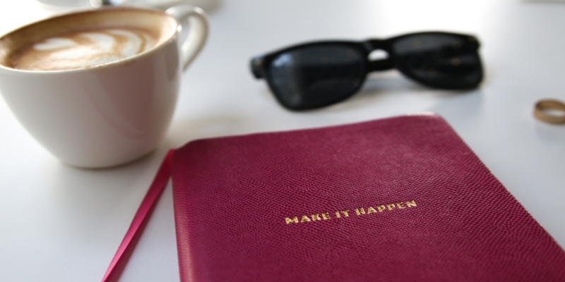 Red Notebook With Embossed Make It Happen Text And Coffee Mug