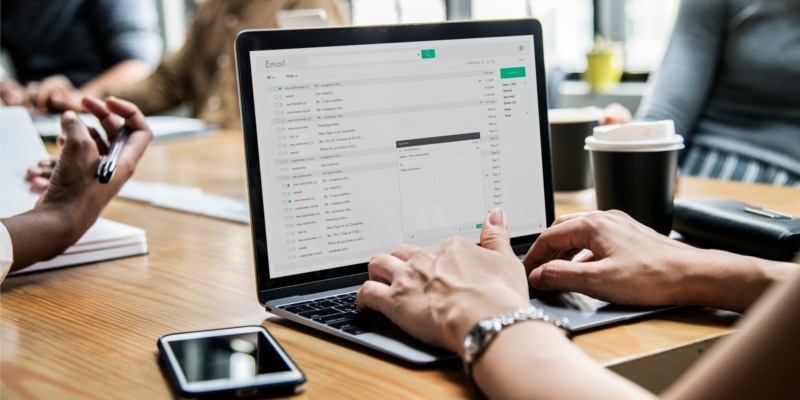 Why Use WordPress Header Image Of Woman Typing On Laptop At Business Meeting Desk