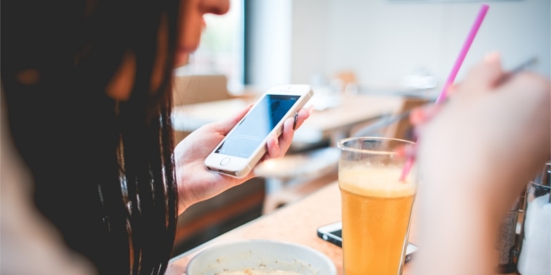 Wordpress Pinterest Plugins Header Image Of Woman Using Social Media On Her Smartphone