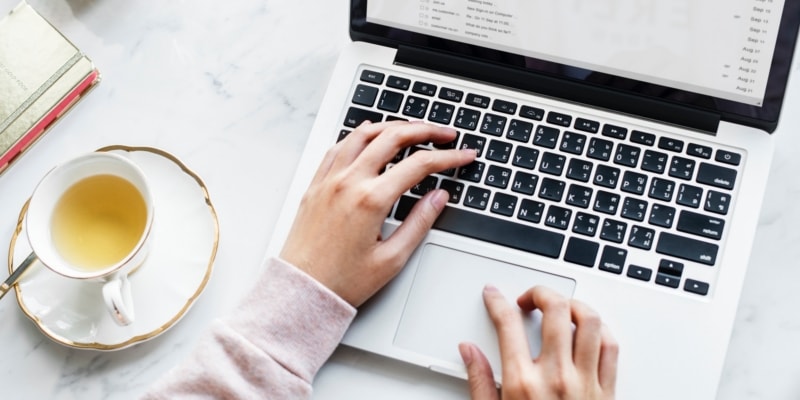Gift Ideas For Bloggers Header Image With Laptop On Marble Surface With Tea