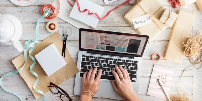Woman Using Laptop On White Wooden Desk With Many Different Stationary Resources