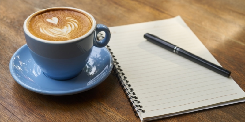 Bloggers Blue Mug Of Coffee With Notebook And Pen Ready To Take Notes On WordPress Permalinks