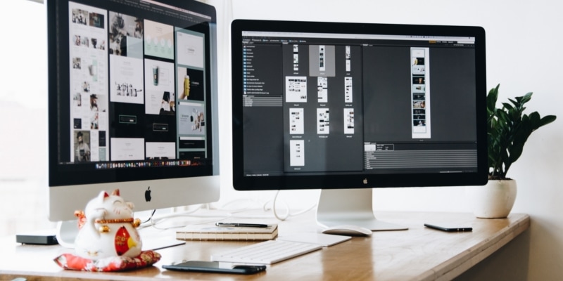Bloggers Work From Home Office With Dual Monitors On Light Wooden Desk