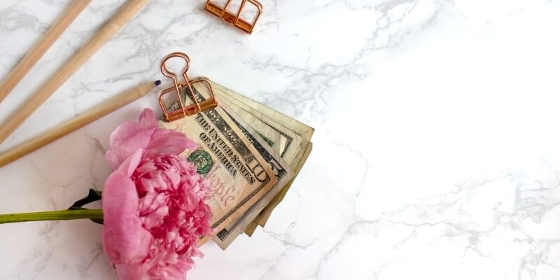The best tools for bloggers make money blogging header image of pink flower and money paper clipped together