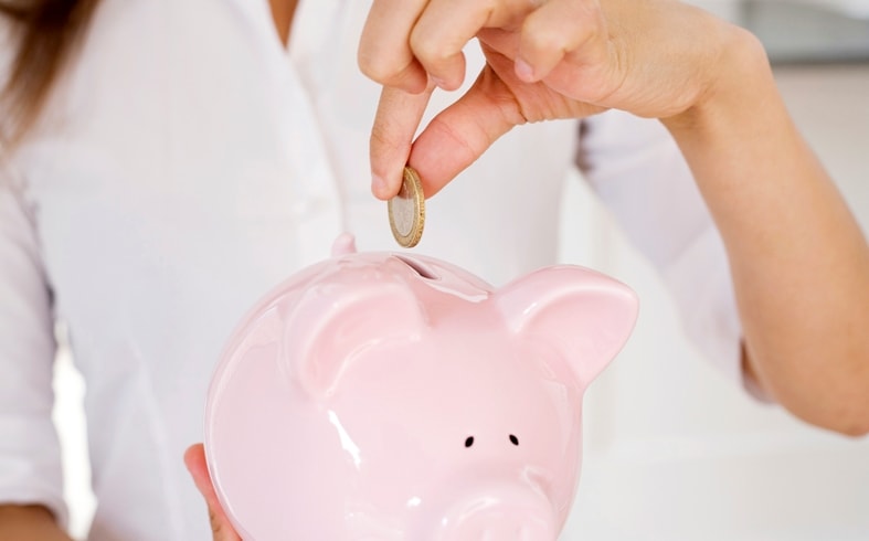 Blogger Making Money And Saving It Into Her Piggy Bank 1